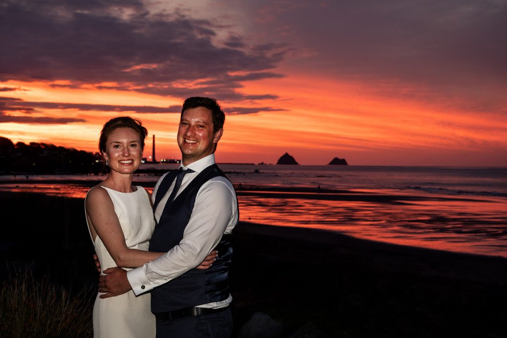 bride and groom in the new zealand sunset