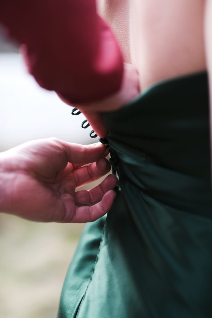 Back detail of the green silk wedding dress with covered buttons.