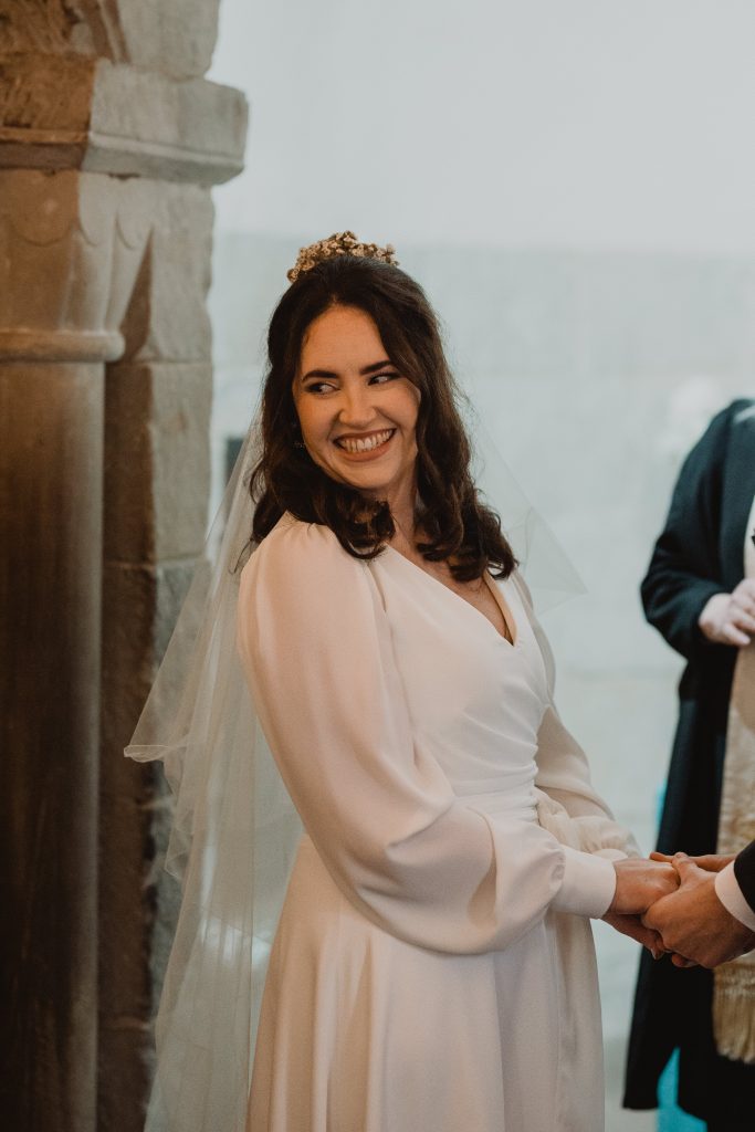 The bride in her dress with flowing sleeves