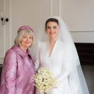 the bride in her timeless wedding dress and mum in the mother of the bride piece