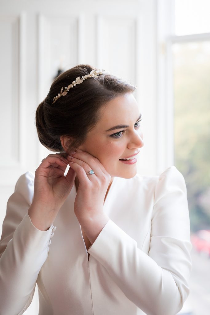 The bride with her accessories alongside her timeless wedding dress