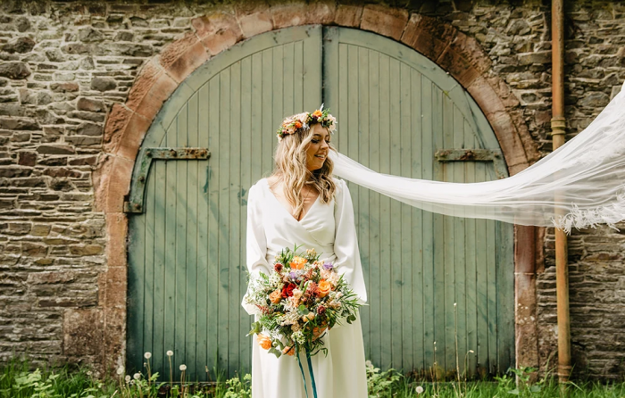 beautiful bride in cross over long sleeved wedding dress in silk satin