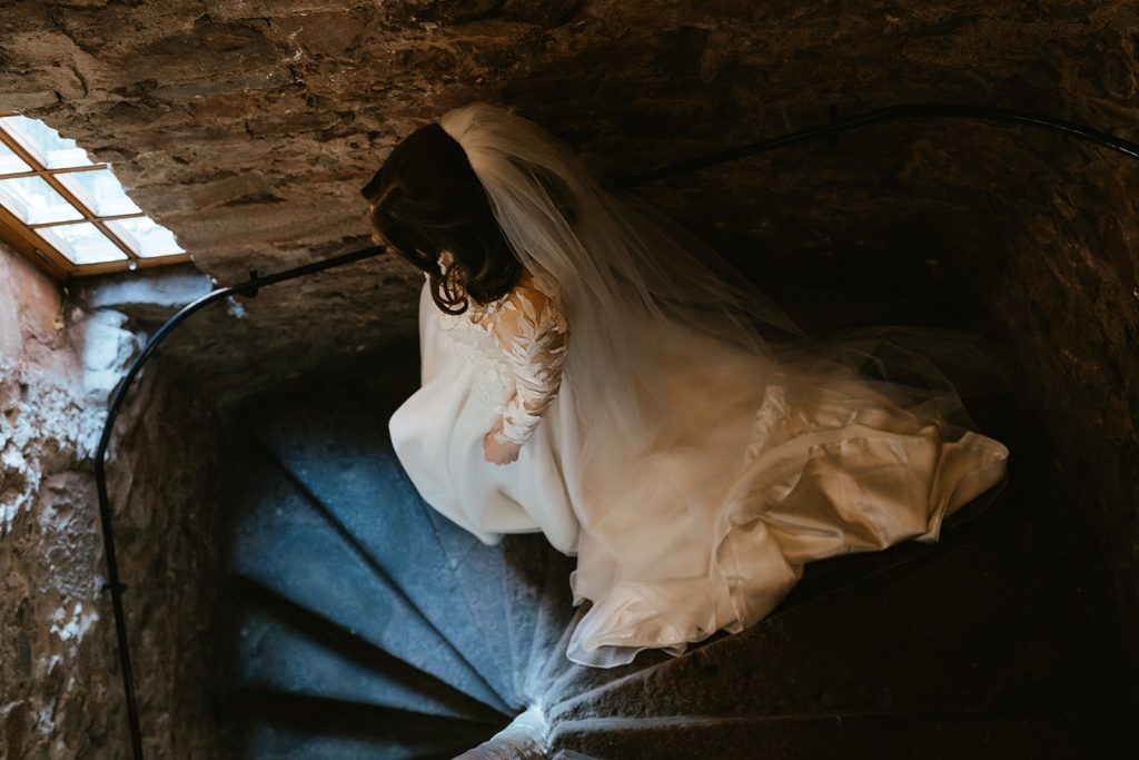 bride walking down spiral staircase